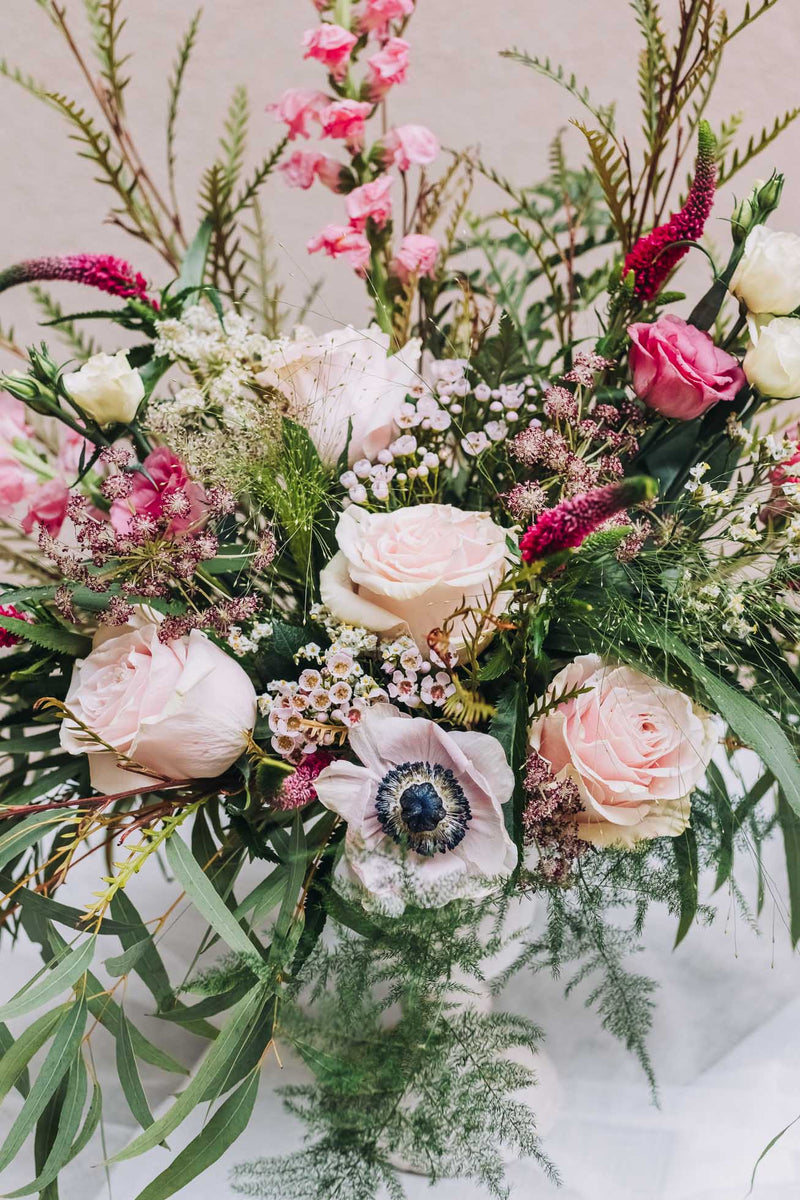 This exquisite blend of lush, textured foliage, vibrant deep pink snapdragons, and delicate light pink anemones crafts an elegant arrangement that radiates joy. Named for a southeast Georgia town celebrated for its captivating charm and tight-knit community spirit.