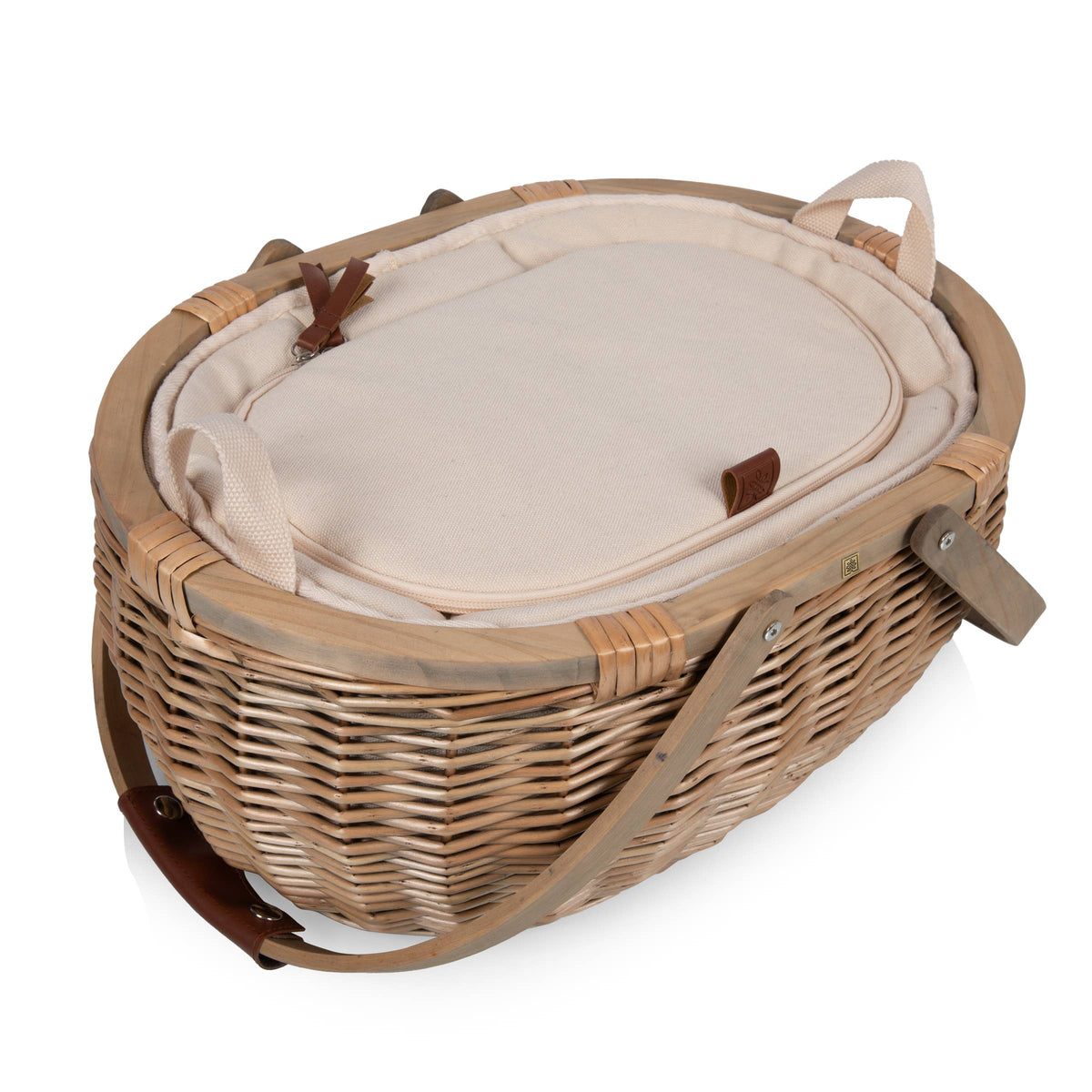 Beige wicker picnic basket with cream insulated lining and brown leather handles, lid open