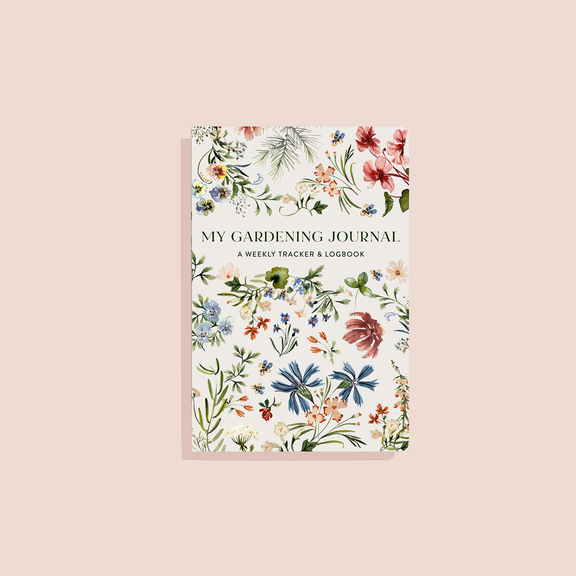 My Gardening Journal with cream cover featuring botanical watercolor flowers in red, blue, orange, and green illustration