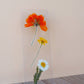 Clear acrylic bookmark with pressed orange, yellow, and white flowers arranged vertically with green stems on white base