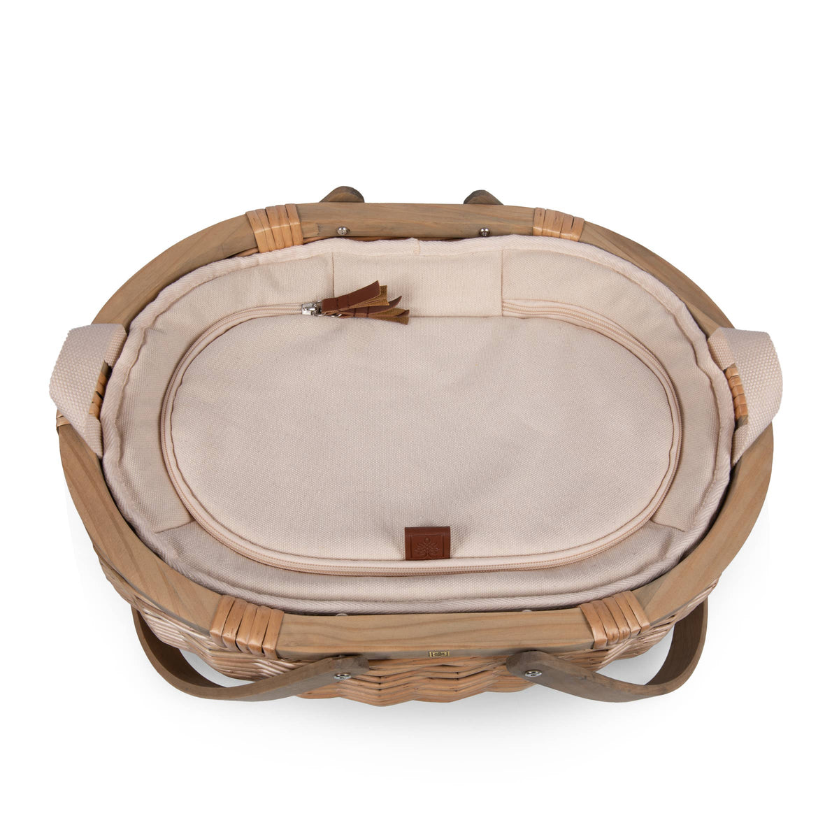 Handwoven wicker picnic basket interior with cream fabric lining, brown leather accents, tan woven handles, and classic English-style details.