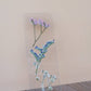 Transparent floral bookmark with pressed purple baby's breath, blue forget-me-nots, and delicate flowers on clear acrylic, white base.