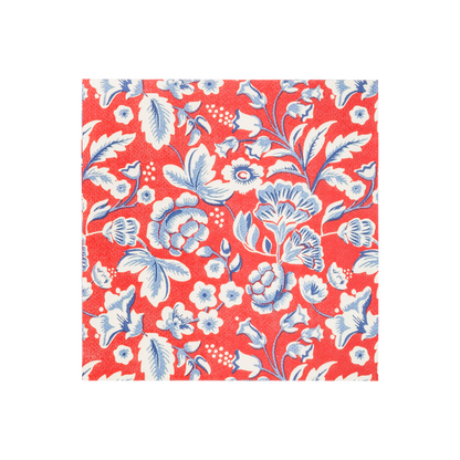 Red cocktail napkin with white and blue floral pattern featuring stylized flowers, leaves, and botanical details throughout the design