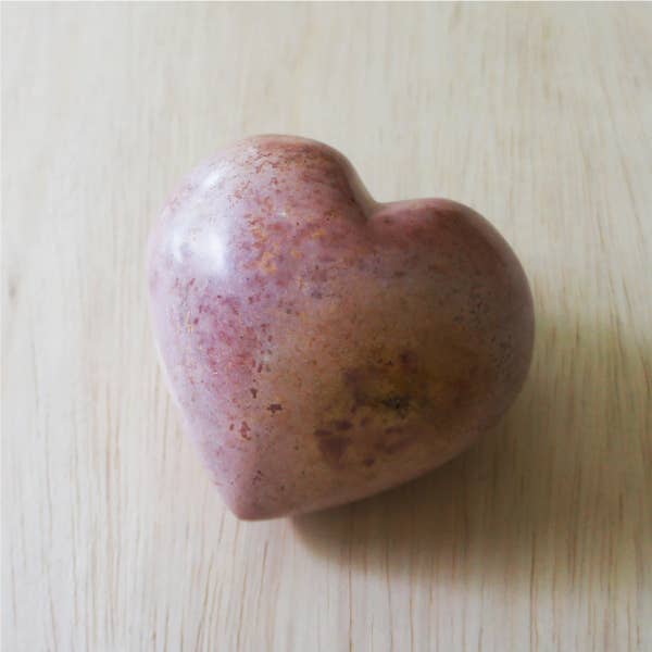 Hand-carved soapstone heart with dusty rose and speckled natural stone finish, polished smooth.