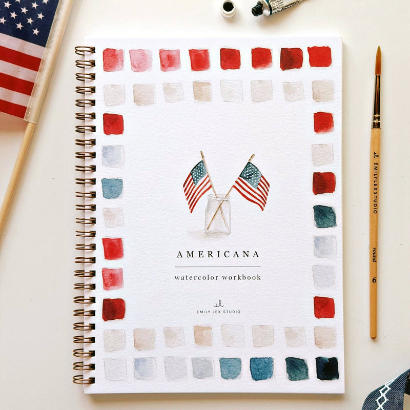 Spiral-bound Americana watercolor workbook with flag illustrations, surrounded by color swatches in reds, pinks, creams, and teals