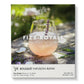 Peachy-pink sparkling Fizz Royale cocktail in a glass, garnished with fresh purple lavender, surrounded by lavender flowers on weathered wood