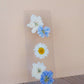 Clear bookmark displaying white daisy and blue forget-me-not pressed flowers arranged vertically on transparent resin base