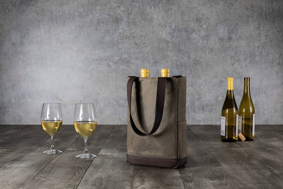 Tan and brown insulated wine tote with black handles holding two bottles, displayed with filled wine glasses and additional bottles on wooden surface