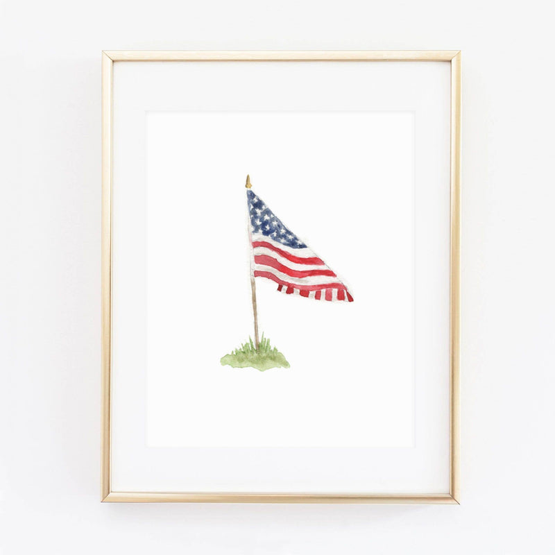 Watercolor American flag print in natural wood frame, blue canton with stars, red and white stripes, mounted on pole with green grass base