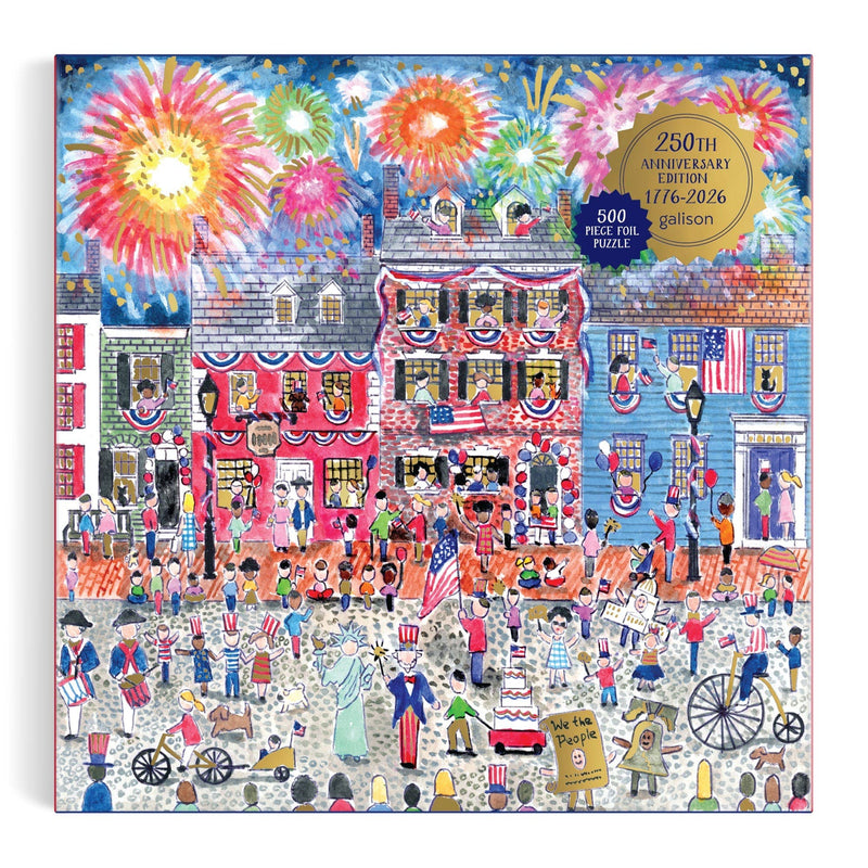 500-piece jigsaw puzzle box with foil finish featuring a vibrant boardwalk celebration scene with fireworks, decorated patriotic building, and crowds of people.