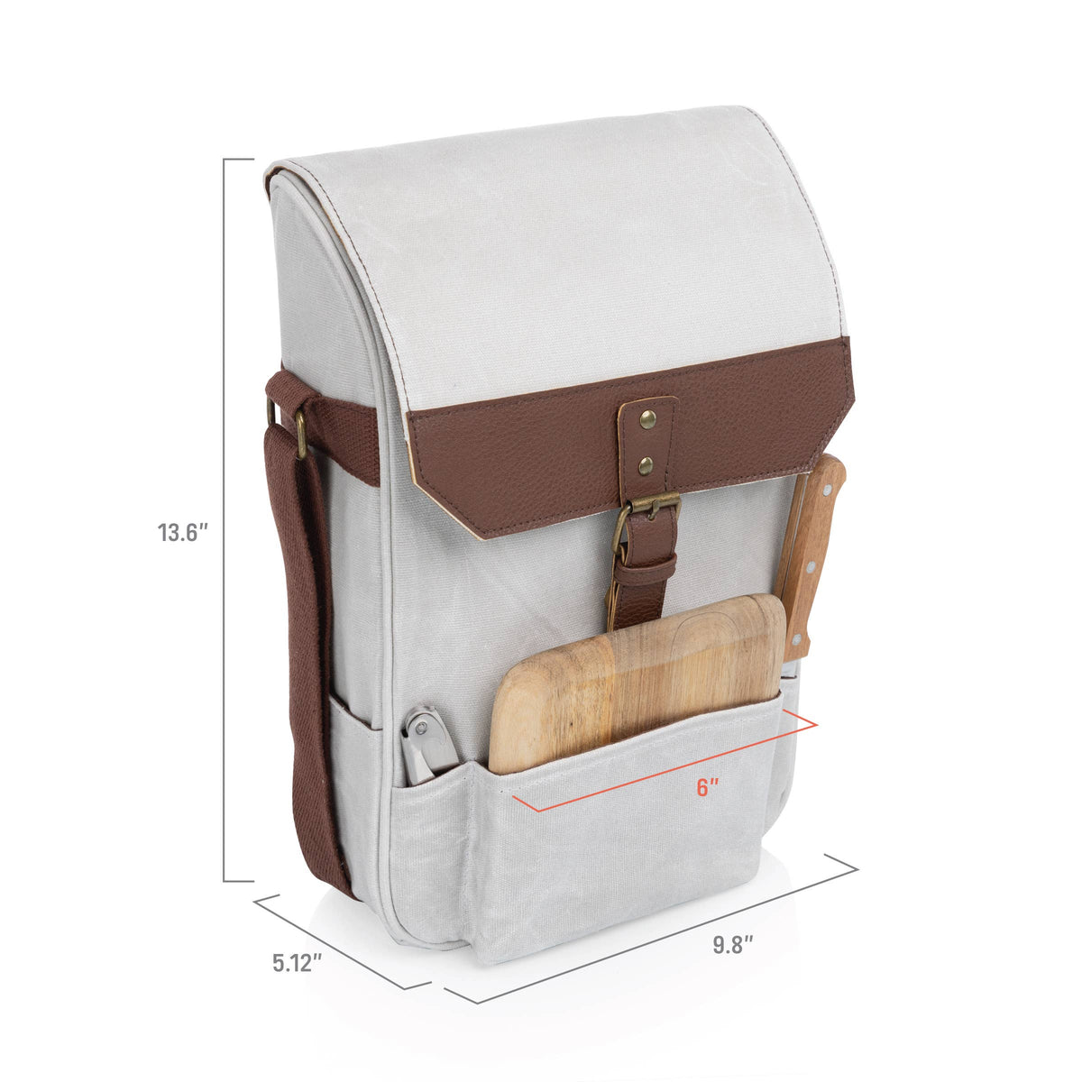 Cream insulated wine tote with brown leather band and wood-handled cheese knife, brass hardware and adjustable shoulder strap