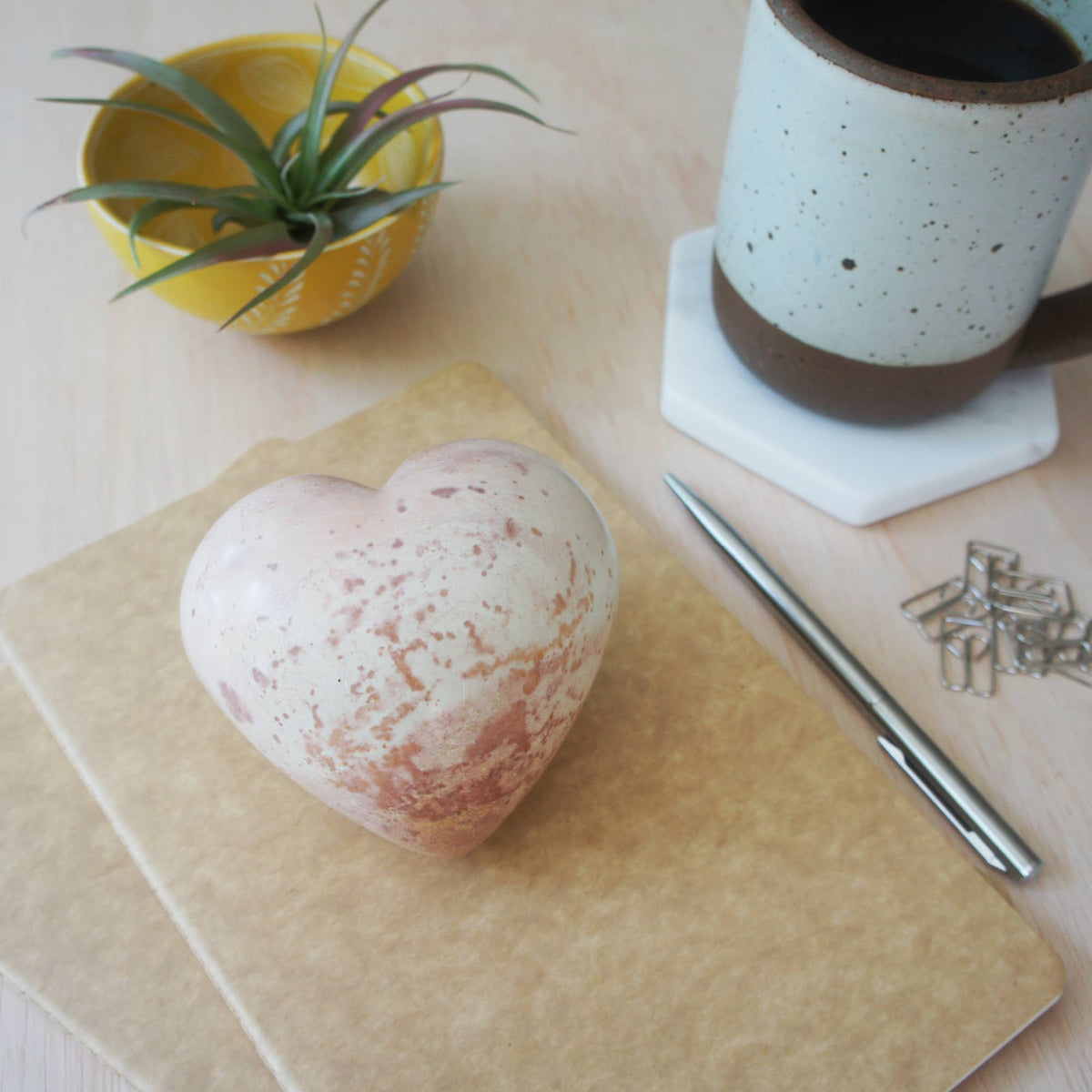 Smooth soapstone heart in cream and terracotta tones with natural veining, hand-carved and polished stone