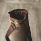 Distressed waxed canvas wine tote bag in tan with brown leather shoulder strap and gold-tone hardware, open top showing insulated interior lining.
