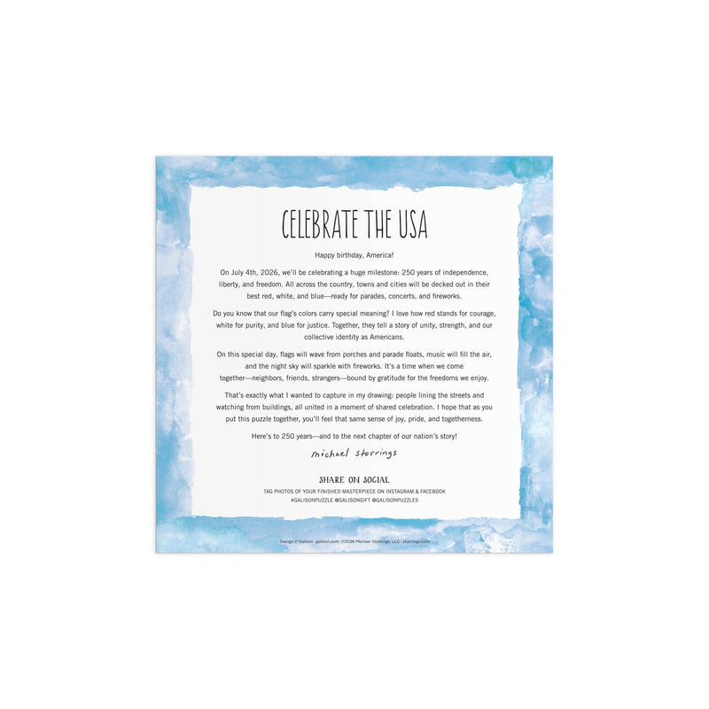 Celebrate the USA puzzle box insert with blue watercolor border and centered patriotic text describing the 500-piece jigsaw puzzle by Michael Storrings