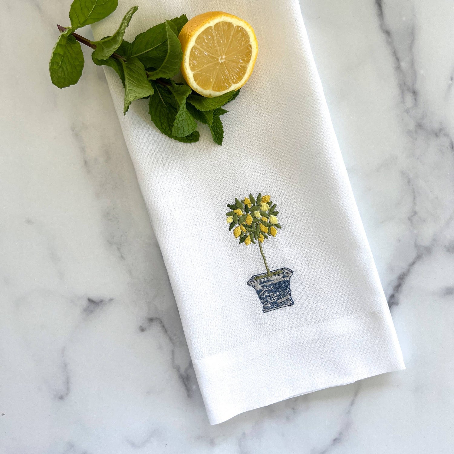 White linen embroidered kitchen towel with yellow flower in decorative pot design