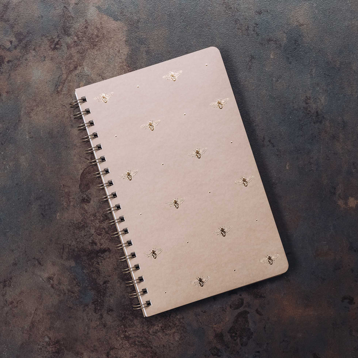 Taupe spiral journal with scattered gold bee motifs on cover, Classic Bee design