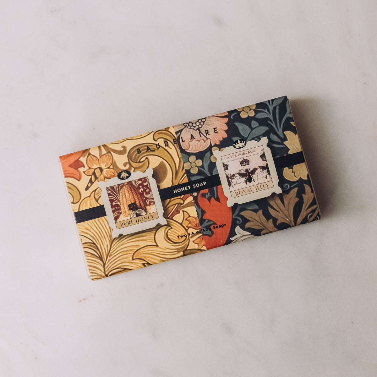 Baudelaire Honey Soap Matchbox Duo in decorative botanical-print box featuring Pure Honey and Royal Jelly varieties with vintage postage label design.