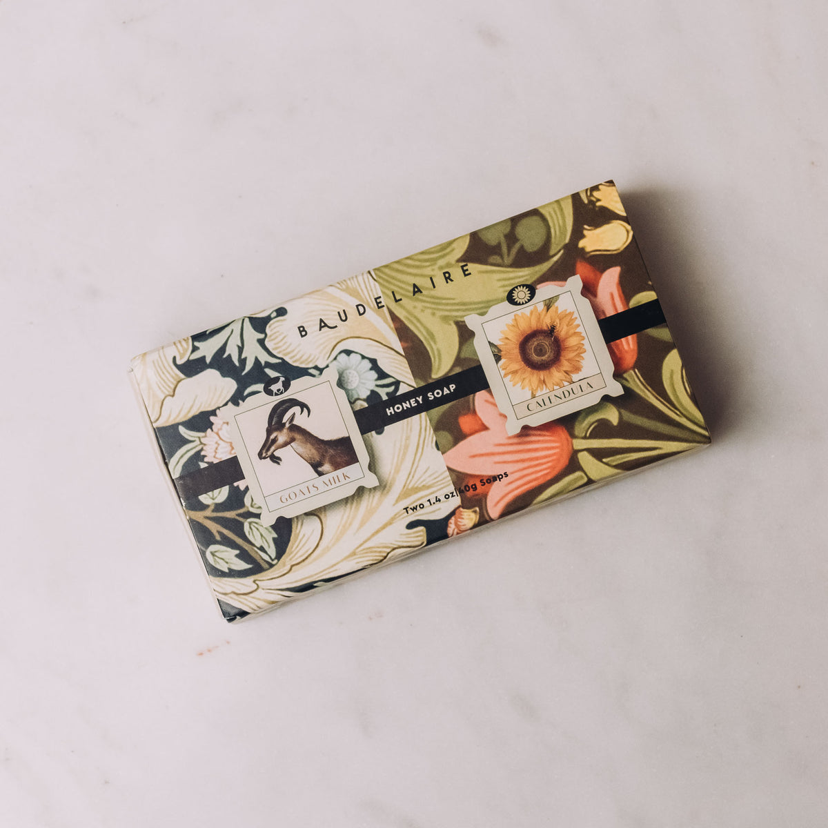 Baudelaire Honey Soap Matchbox Duo with goat's milk and calendula bars in decorative botanical packaging on white background.