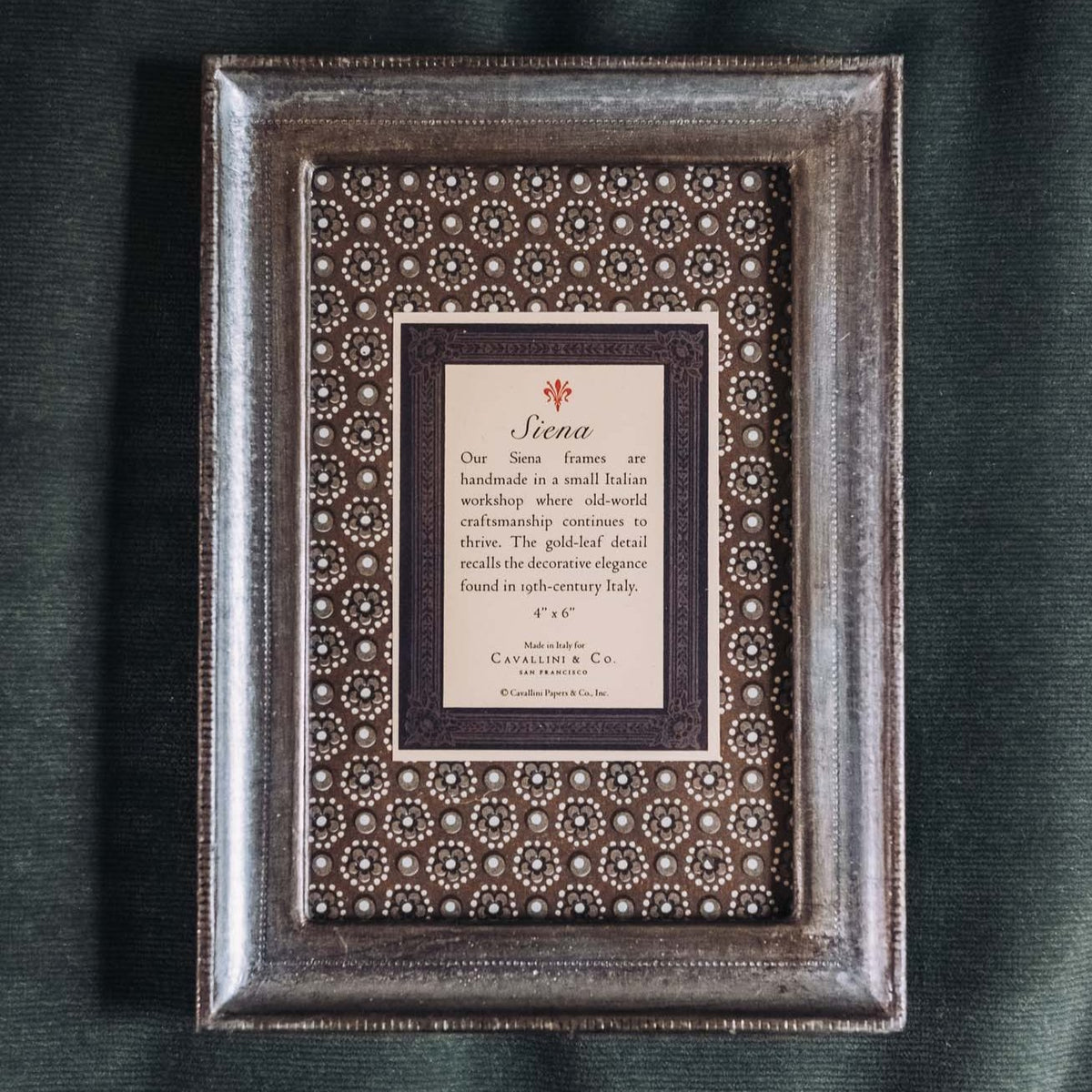 Silver-leafed wooden frame with ornate patterned mat, nested rectangular design, on neutral background. Cavallini Siena tabletop frame.