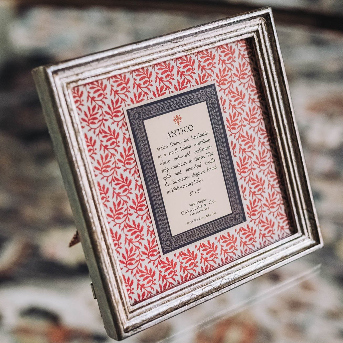 Silver-finish Italian frame with red botanical-patterned mat and decorative borders, displaying Antico product label