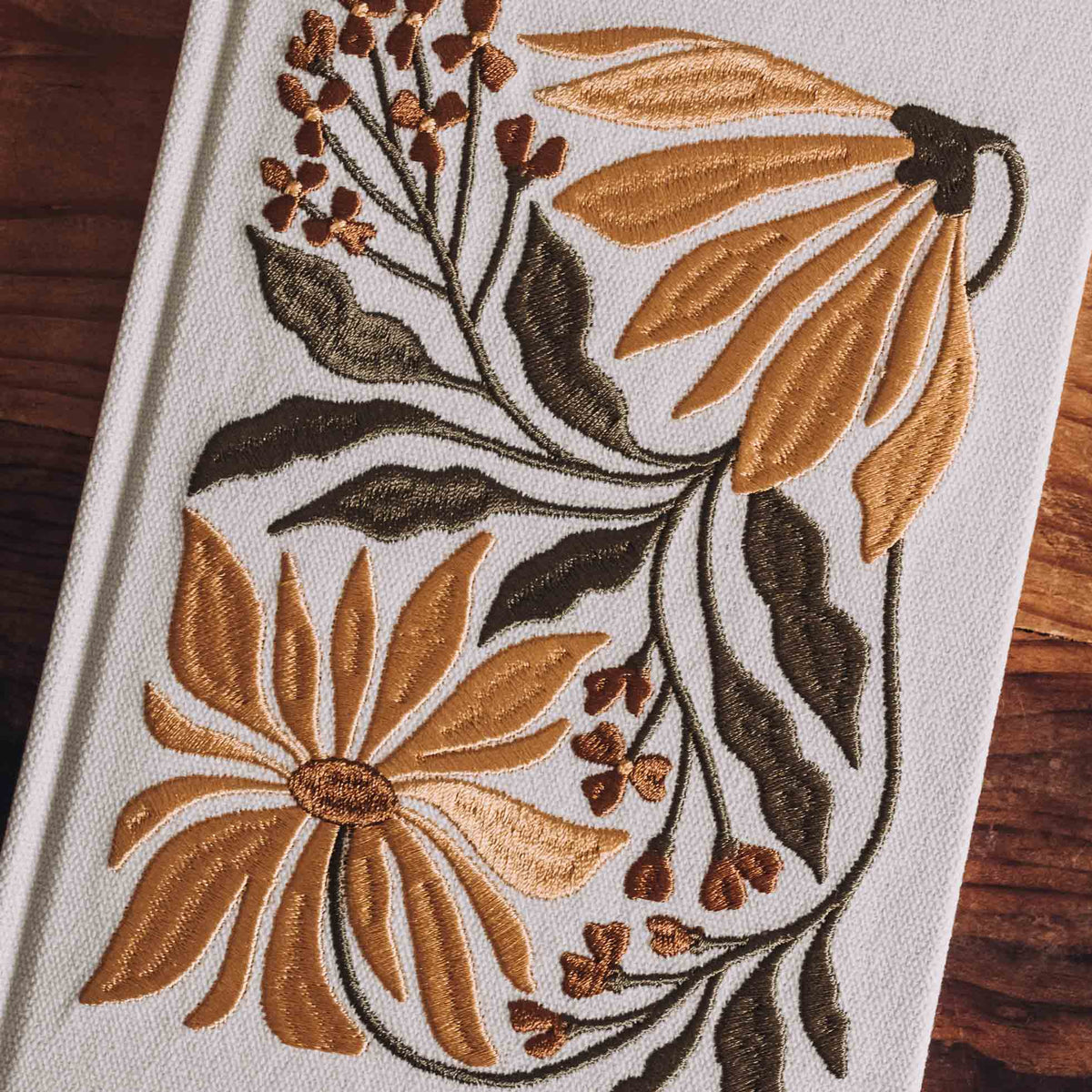 Cream hardcover journal with embroidered sunflowers and florals in gold and brown thread