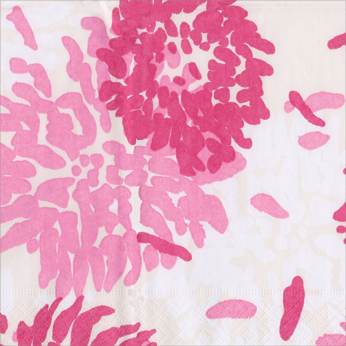 Red and pink chrysanthemums with scattered petals on cream cocktail napkin