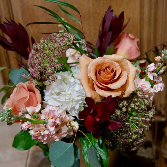 Bouquet of flowers on a wooden surface with a wooden background