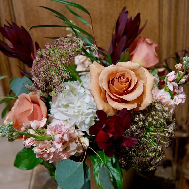 Bouquet of flowers on a wooden surface with a wooden background