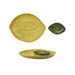 Yellow stoneware lemon-shaped platter with dimpled texture and matching green leaf-shaped dish set
