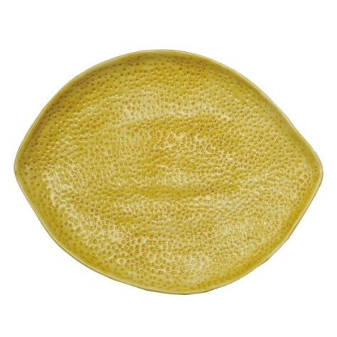 Yellow stoneware lemon-shaped platter with textured dimpled surface
