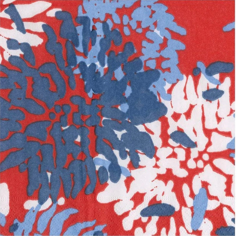 Caspari triple-ply cocktail napkin with abstract coral-inspired pattern in navy, light blue, white, and red on bright red background