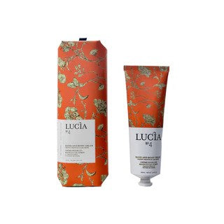 Lucia hand cream tube and matching cylindrical box with red damask floral pattern and white label