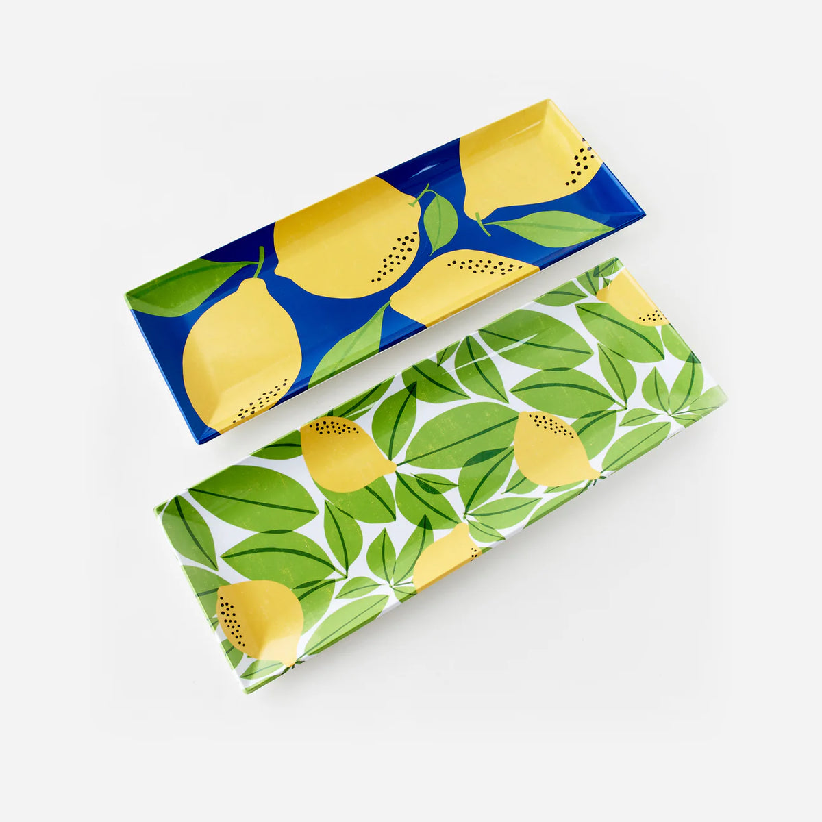 Two melamine sandwich platters with lemon and leaf prints—one navy and yellow, one white with green foliage