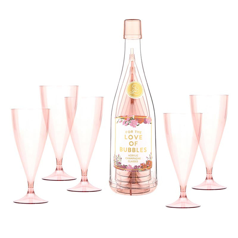 Set of five soft pink acrylic champagne flutes arranged around decorative bottle with 'For The Love of Bubbles' label