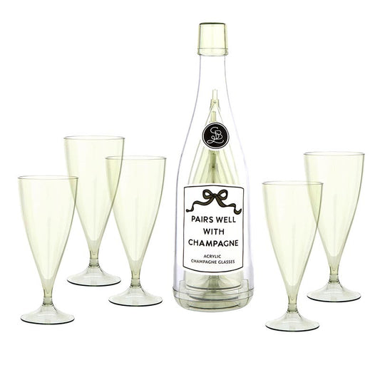 Set of 5 clear acrylic champagne flutes with pedestal stems arranged around a champagne bottle labeled "Pairs Well With Champagne"