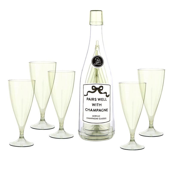 Set of 5 clear acrylic champagne flutes with pedestal stems arranged around a champagne bottle labeled "Pairs Well With Champagne"