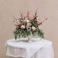 This exquisite blend of lush, textured foliage, vibrant deep pink snapdragons, and delicate light pink anemones crafts an elegant arrangement that radiates joy. Named for a southeast Georgia town celebrated for its captivating charm and tight-knit community spirit.