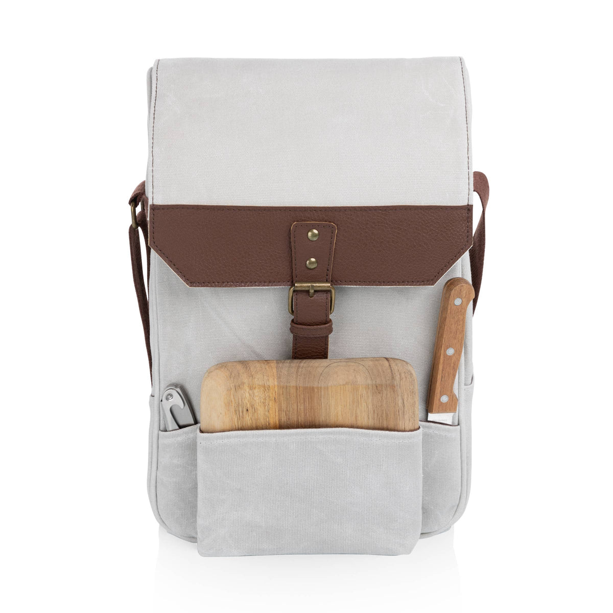 Cream canvas and brown leather wine tote with wooden cutting board and knife in front pocket