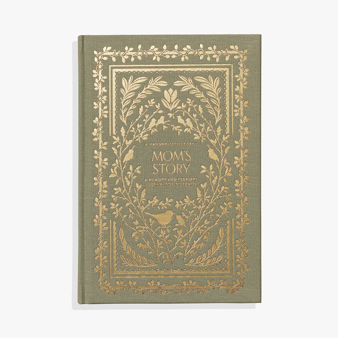 Sage green hardcover journal with gold foil botanical border and leaf design, "Mom's Story" title
