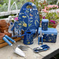 Navy tin with yellow botanical flower illustrations holding 120m of three-ply jute twine, displayed with gardening hand tools and accessories