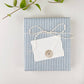 Blue and white striped mini notecard with white envelope, wrapped in twine and sealed with kraft paper sticker