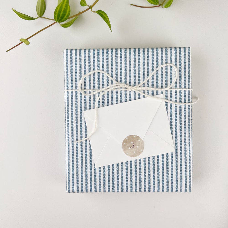 Blue and white striped mini notecard with white envelope, wrapped in twine and sealed with kraft paper sticker
