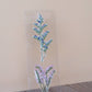 Clear resin bookmark with pressed blue forget-me-nots and lavender flowers in botanical design on acrylic display stand.
