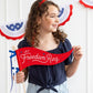 Red felt pennant banner with "Let Freedom Ring" script and stars, displayed against patriotic bunting