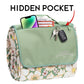 Sage green canvas picnic organizer with floral daisy-print sides, multiple storage pockets, and carry handles