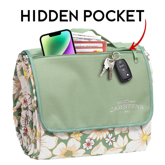 Sage green canvas picnic organizer with floral daisy-print sides, multiple storage pockets, and carry handles