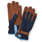 Pair of brown leather and navy gardening gloves with padded blue cuffs and Burgon & Ball branding on wrist strap.