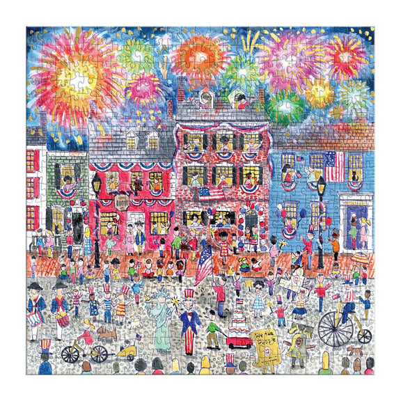 Vibrant 500-piece puzzle depicting a bustling patriotic boardwalk with red-brick buildings, festive crowds, colorful fireworks bursting overhead, and Americana-themed carnival details