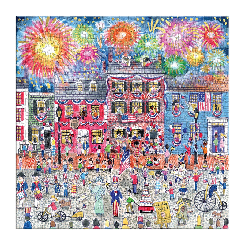 Vibrant 500-piece puzzle depicting a bustling patriotic boardwalk with red-brick buildings, festive crowds, colorful fireworks bursting overhead, and Americana-themed carnival details