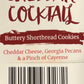 Cheddar Cocktail label with burgundy handwritten text, paintbrush-style banner, and red ingredient list on cream background.